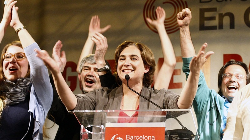 Ada Colau (center), leader of the Barcelona en Comú party, celebrates in Barcelona during a press conference following the results in Spain's municipal and regional elections on May 24. She is the first member of Spain's indignados protest movement to win public offic